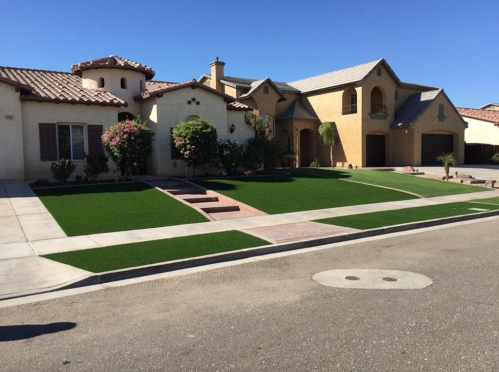 Beautiful residential lawn with lush green grass and landscaping in Arizona.