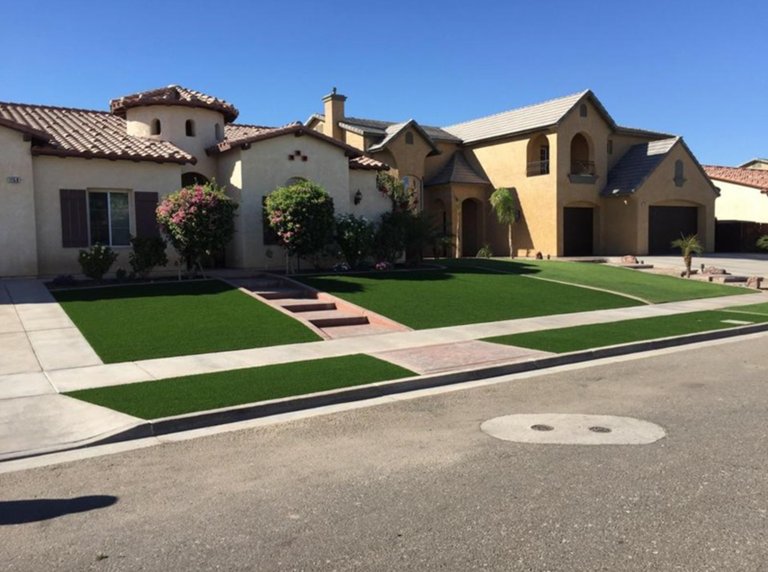 Beautiful residential lawn with lush green grass and landscaping in Arizona.