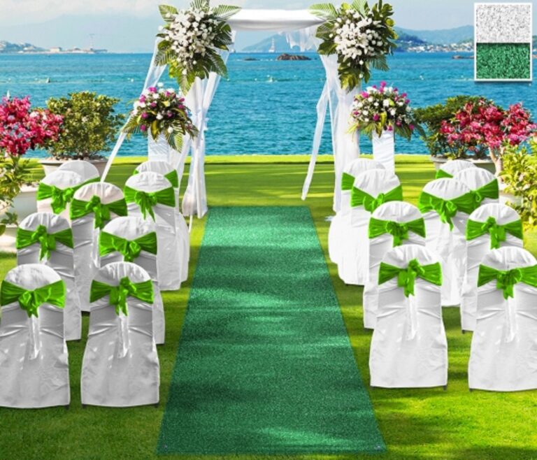 Artificial grass aisle runner for outdoor wedding ceremony by the water.