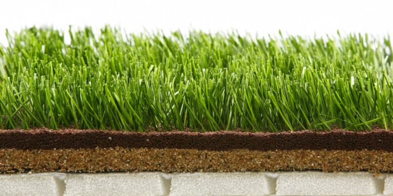 Close-up of lush artificial grass with layered infill for durability.