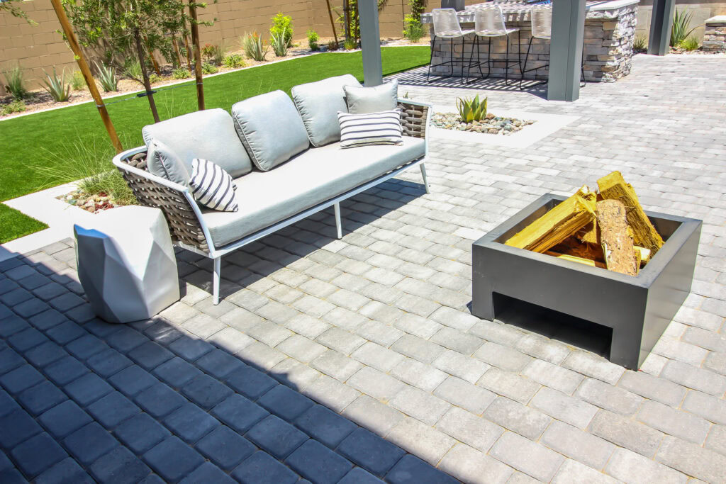 Elegant outdoor patio with interlocking concrete pavers and fire pit.