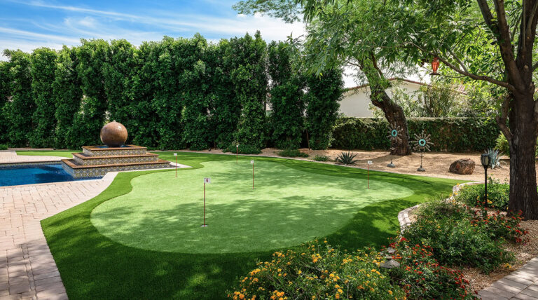 Artificial turf putting green in a luxurious backyard setting.