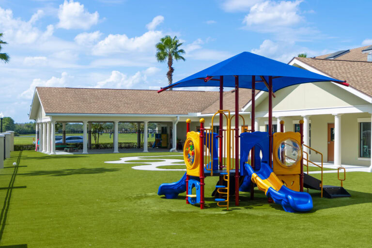 School playground with vibrant play structures and turf for children.