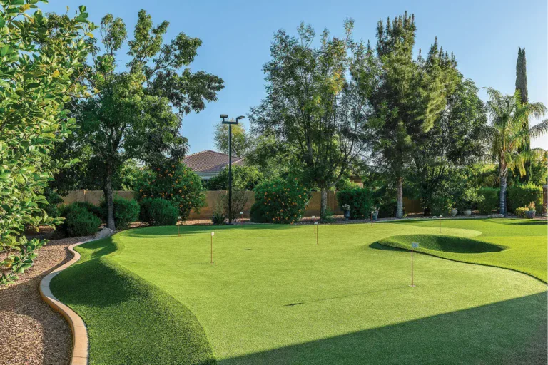 Beautiful artificial turf putting green with lush grass and trees in Arizona.