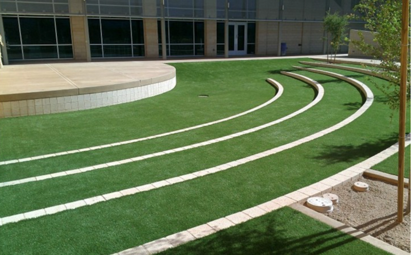Artificial turf with curved white lines for a golf putting green.