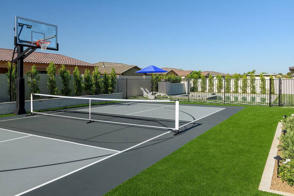 Beautiful backyard with tennis court and lush green lawn in Arizona.