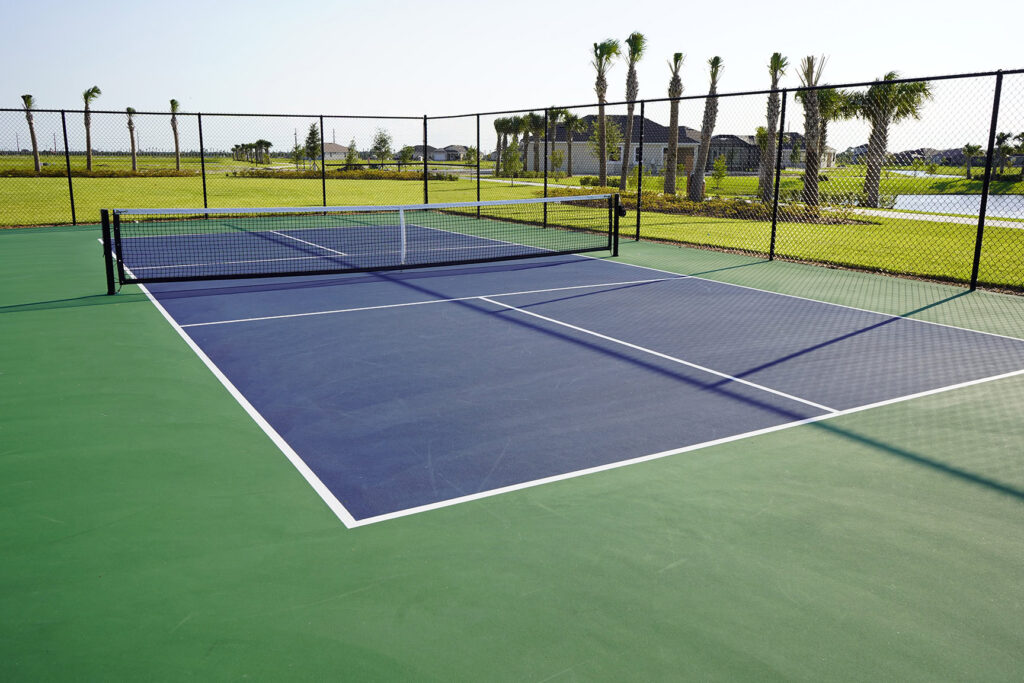 Tennis court with synthetic turf and surrounding fence in Arizona.