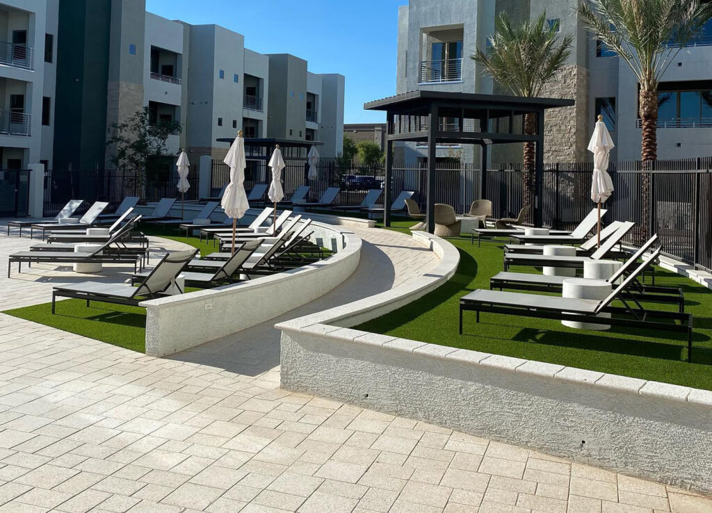 Luxury outdoor pool area with lounge chairs and umbrellas in Arizona.