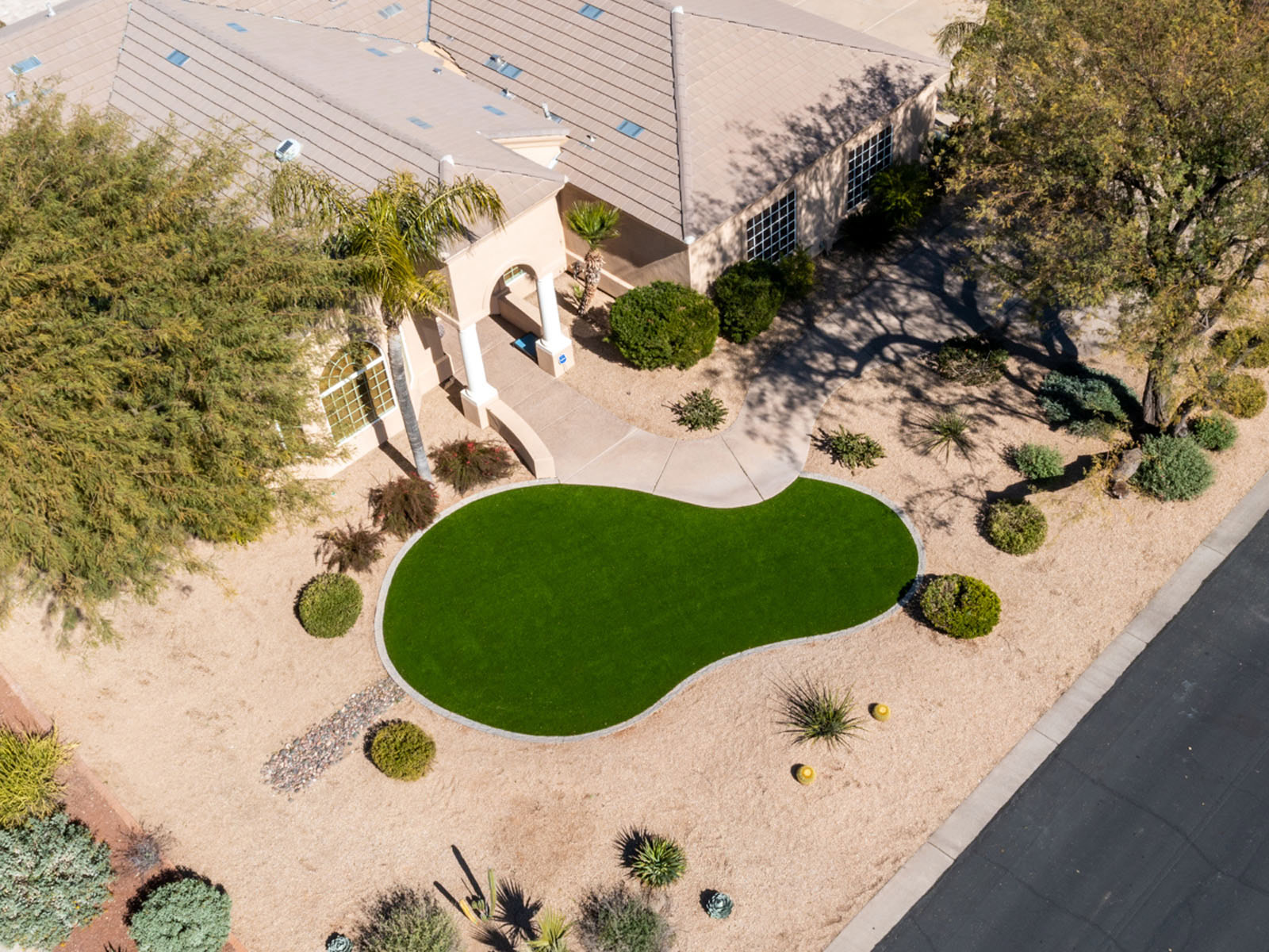Aerial view of artificial turf and hardscaping installed in Queen Creek, AZ
