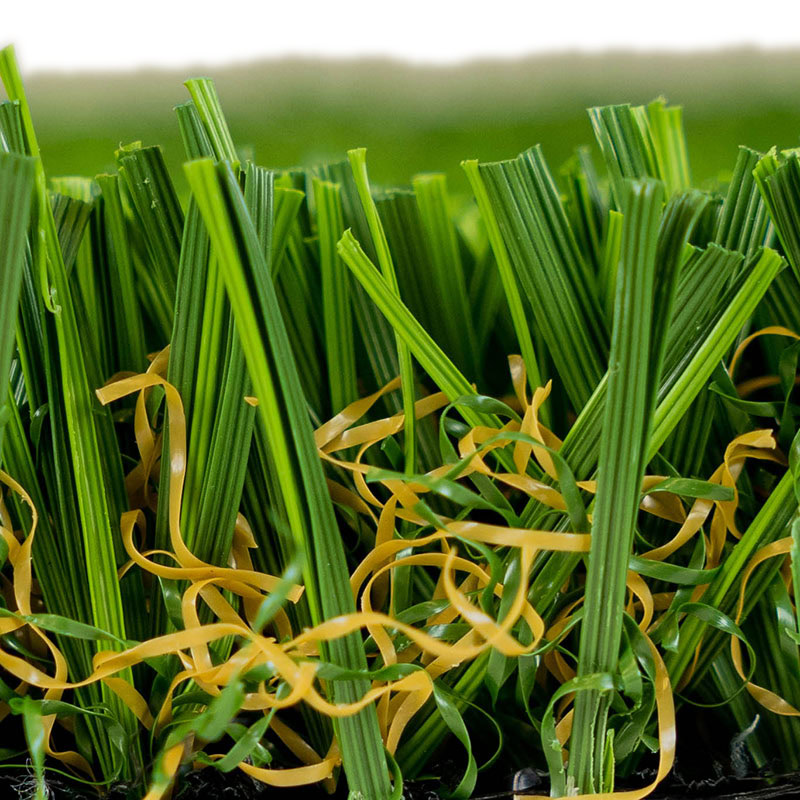 Close-up of lush green artificial grass with yellow accents for luxury lawns.