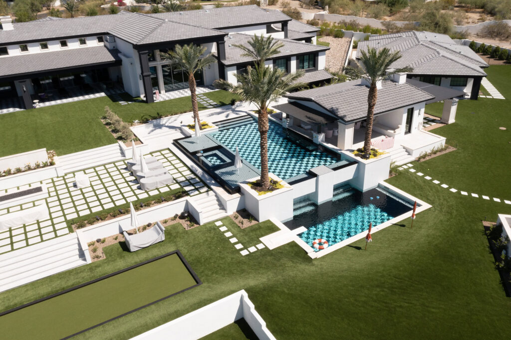Luxury backyard with custom putting green and pool in Arizona.