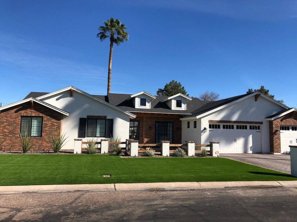 Beautiful residential lawn with lush green grass and a tall palm tree.