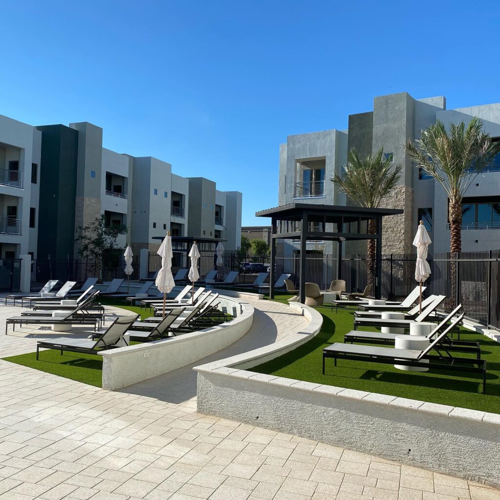 Luxury outdoor pool area with putting greens and lounge chairs in Arizona.
