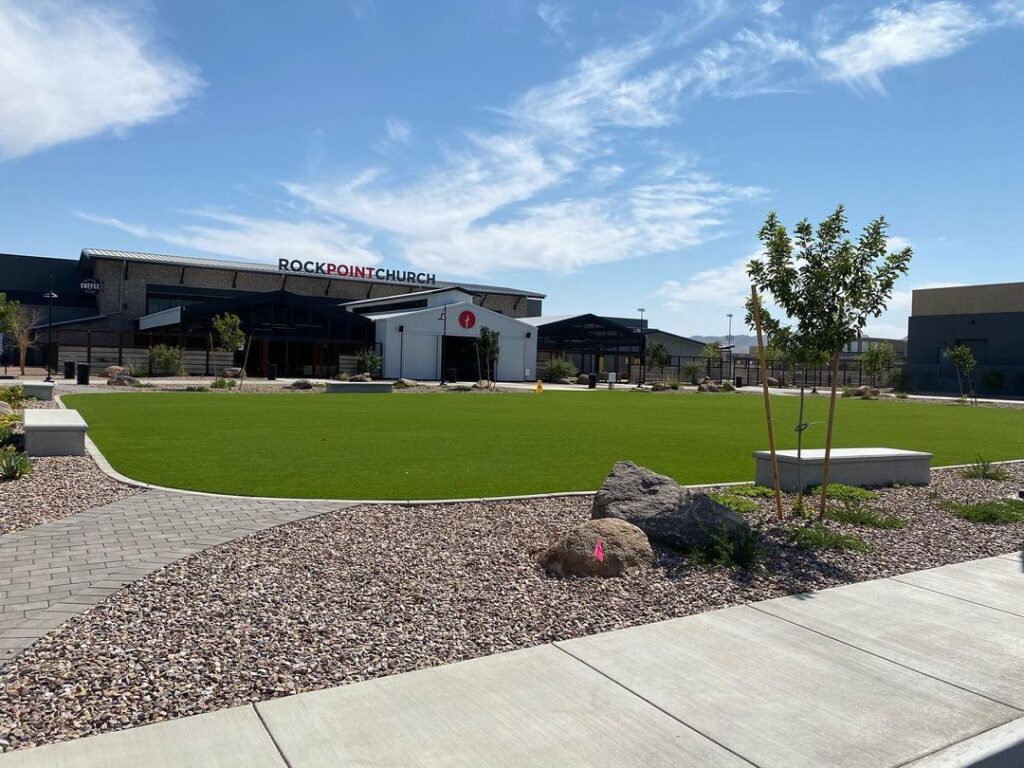 Beautiful landscaped lawn with putting green and modern church building in Arizona.